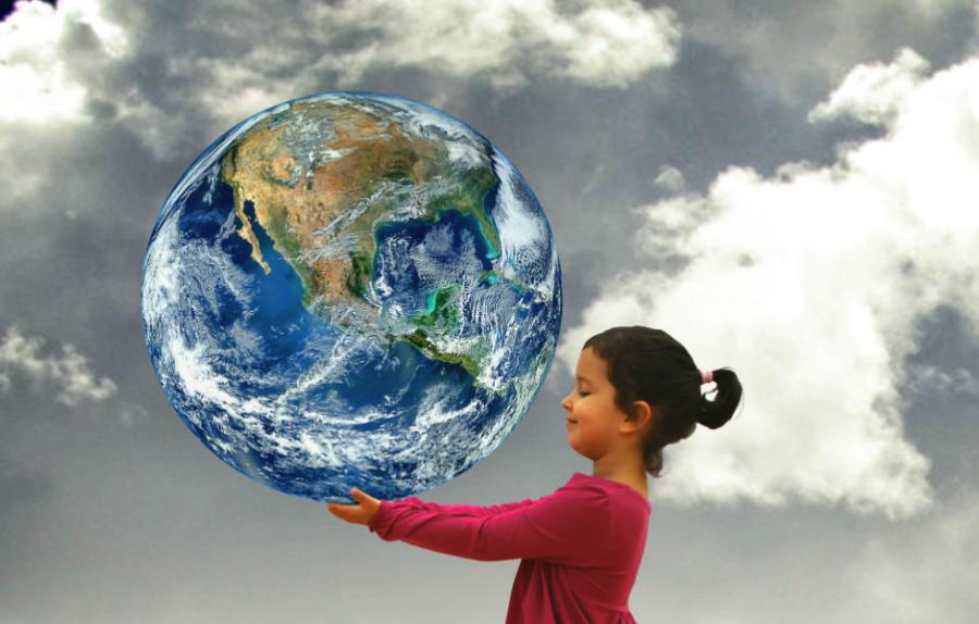 Child holding planet Earth